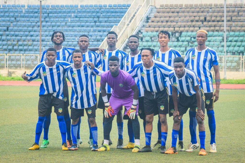 Leal FC players dressed in white and blue striped shirts pose for a team photo before a match. 