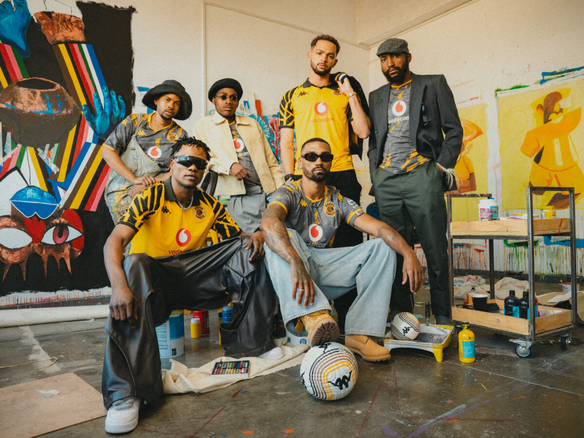 six men dressed in kaizer chiefs' merchandise